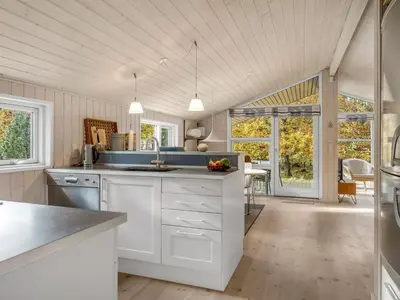 a kitchen with white cabinets and a counter top at Holiday Home Peder - 4km from the sea by Interhome in Fjerritslev