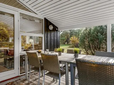 an outdoor patio with a table and chairs at Holiday Home Peder - 4km from the sea by Interhome in Fjerritslev