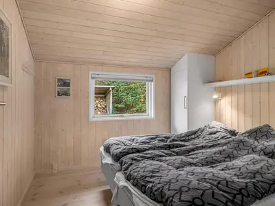a small bedroom with a bed and a window at Holiday Home Peder - 4km from the sea by Interhome in Fjerritslev