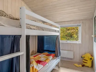a bedroom with two bunk beds and a window at Holiday Home Peder - 4km from the sea by Interhome in Fjerritslev