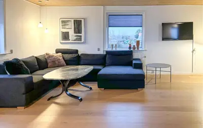 a living room with a couch and a table at Awesome Home In Thisted With House Sea View in Thisted