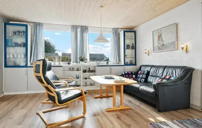 a living room with a couch and a table at Amazing Home In Snedsted With Wifi in Snedsted