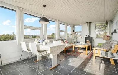 a living room with a table and chairs and windows at Amazing Home In Snedsted With Wifi in Snedsted