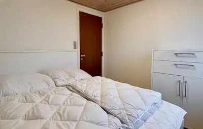 a bedroom with two unmade beds and a dresser at 5 Bedroom Awesome Home In Lemvig in Lemvig