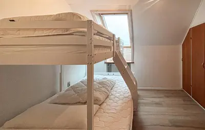 a bedroom with two bunk beds and a window at 5 Bedroom Awesome Home In Lemvig in Lemvig
