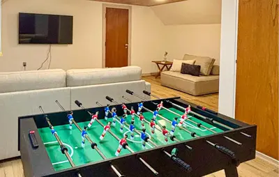 a living room with a table with a large pool table at 5 Bedroom Awesome Home In Lemvig in Lemvig