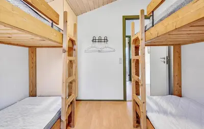 two bunk beds in a room with wooden ceilings at Lovely Home In Hanstholm With Private Swimming Pool, Can Be Inside Or Outside in Hanstholm