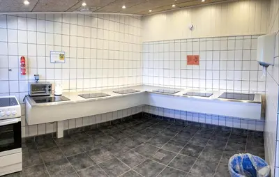 a kitchen with white tiled walls and a counter at Lovely Home In Hanstholm With Private Swimming Pool, Can Be Inside Or Outside in Hanstholm