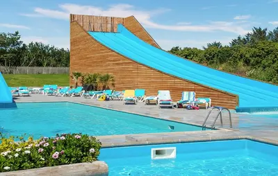 a swimming pool with a slide in front of a house at 2 Bedroom Beautiful Home In Hanstholm in Hanstholm