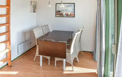 a dining room table and chairs in a room at Stunning Home In Hanstholm With Outdoor Swimming Pool in Hanstholm