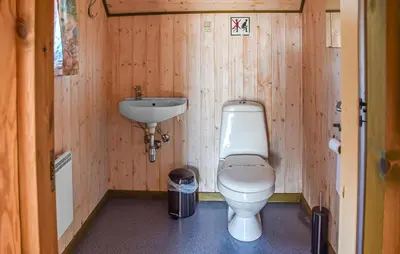 a small bathroom with a toilet and a sink at Gorgeous Home In Hanstholm With Outdoor Swimming Pool in Hanstholm
