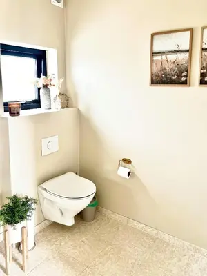 a bathroom with a toilet and a window at Summer House Surrounded By Reeds Near Limfjorden in Lemvig