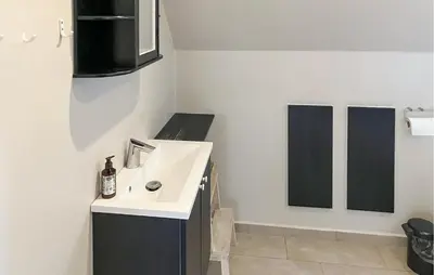a white bathroom with a sink and a mirror at 2 Bedroom Stunning Home In Lemvig in Lemvig