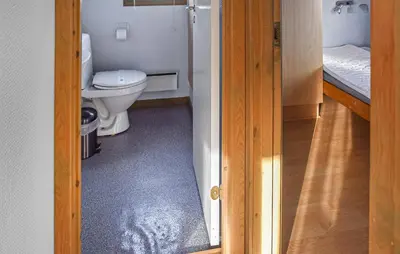 a bathroom with a toilet and a door open at Beautiful Home In Hanstholm With Swimming Pool in Hanstholm