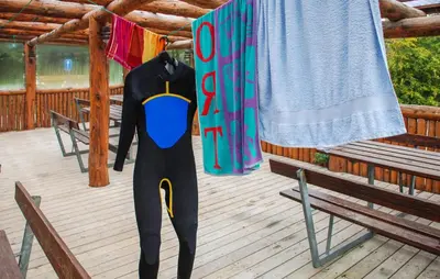 a person in a wetsuit standing on a deck at 2 Bedroom Stunning Home In Hanstholm in Hanstholm