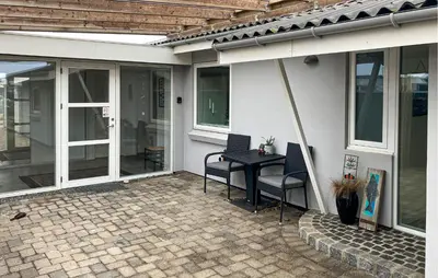 a patio with a table and chairs on a house at Awesome Home In Thyborøn With Wifi in Thyborøn