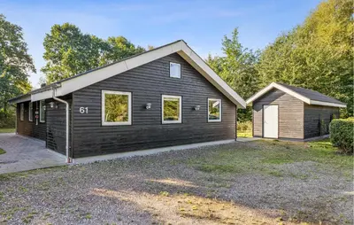 a black house with a garage at Gorgeous Home In Farsø With Wifi in Farsø
