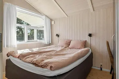 a large bed in a room with a window at JB368-Fjerritslev-Ahornvej-38