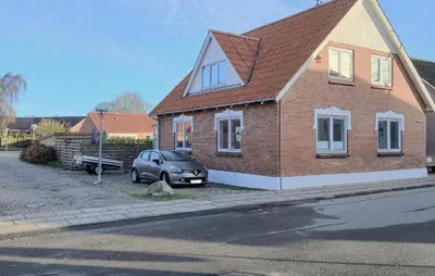 a car parked in front of a brick house at Nice Home In Thyholm With Wifi in Thyholm