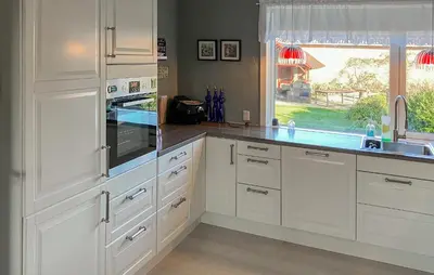 a kitchen with white cabinets and a sink and a window at 3 Bedroom Cozy Home In Bøvlingbjerg in Bøvlingbjerg