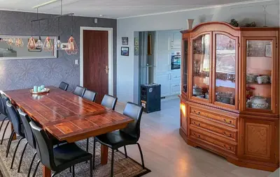 a dining room with a wooden table and chairs at 3 Bedroom Cozy Home In Bøvlingbjerg in Bøvlingbjerg