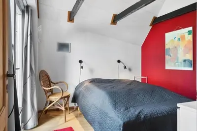 a bedroom with a bed and a red wall at 534-Lemvig-Lokkevej-13 in Lemvig