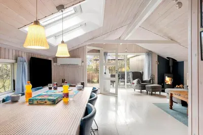 a living room with a table and chairs and a dining room at LF16082-Farso-Kjeldhoj-82 in Ertebølle
