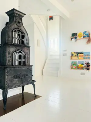 a black bird cage sitting on a floor in a room at Villa With Fjord View By Frederik Vii's Canal in Løgstør