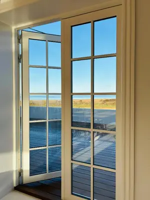 an open door with a view of a deck at Villa With Fjord View By Frederik Vii's Canal in Løgstør
