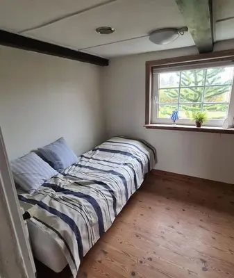 a bed in a room with a window at Horse Estate Farm Stay - Beautiful Surroundings in Bøvlingbjerg