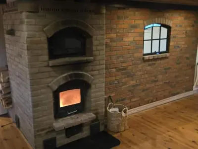 a brick fireplace in a room with a window at Horse Estate Farm Stay - Beautiful Surroundings in Bøvlingbjerg