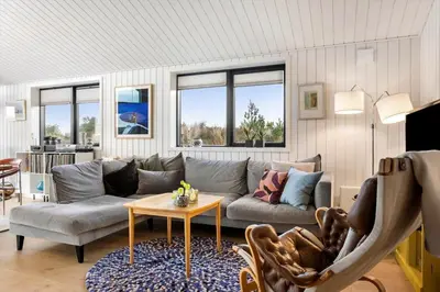 a living room with a couch and a table at 1071-Thisted-Gravsesvej-30 in Klitmøller