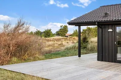 a wooden deck with a pavilion in a field at 1071-Thisted-Gravsesvej-30 in Klitmøller