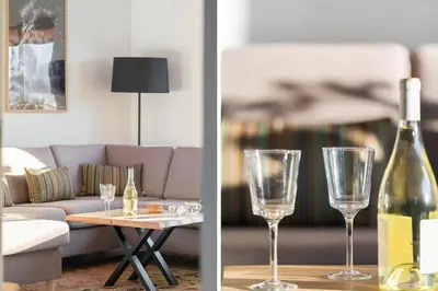 a living room with a couch and a bottle of wine at 729-Thyboron-Vesterhavsgade-112 in Thyborøn