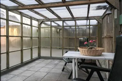 a greenhouse with a table and a basket on it at 729-Thyboron-Vesterhavsgade-112 in Thyborøn