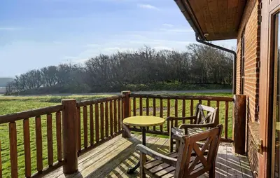 a porch with two chairs and a table on a balcony at Gorgeous Home In Lemvig With Wifi in Lemvig