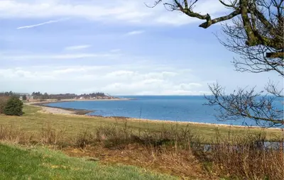 a view of the ocean from a grassy field at Gorgeous Home In Lemvig With Wifi in Lemvig