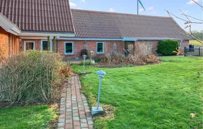 a brick house with two parking meters in the yard at 6 Bedroom Awesome Home In Hurup Thy in Tvolm