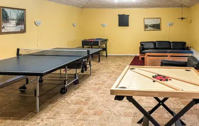 a ping pong room with two ping pong tables at 6 Bedroom Awesome Home In Hurup Thy in Tvolm