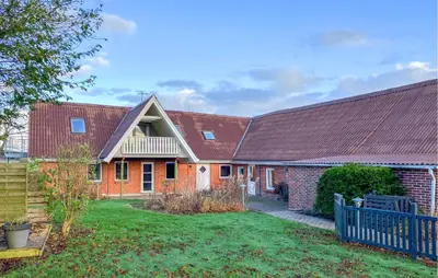 a house with a red roof and a yard at 6 Bedroom Awesome Home In Hurup Thy in Tvolm