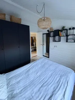 a bedroom with a large white bed in a room at Log Cabin With Hot Tub And Fjord View in Viborg