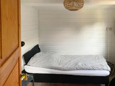 a small room with a bed in the corner at Log Cabin With Hot Tub And Fjord View in Viborg
