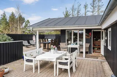 a patio with a white table and chairs at JB301-Fjerritslev-Landstien-3 in Fjerritslev