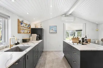 a large kitchen with a sink and a counter top at JB301-Fjerritslev-Landstien-3 in Fjerritslev
