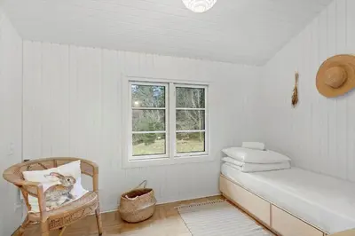 a white room with a bench and a window at JB238-Brovst-Baunehojvej-37 in Brovst