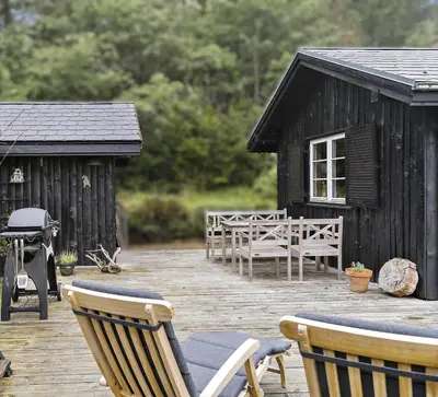a deck with chairs and a table and a house at JB238-Brovst-Baunehojvej-37 in Brovst