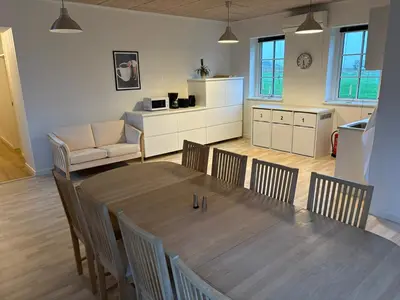 a kitchen and dining room with a table and chairs at Kildebakkegaard Bed and Breakfast in Nørager
