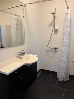 a bathroom with a sink and a shower at Kildebakkegaard Bed and Breakfast in Nørager