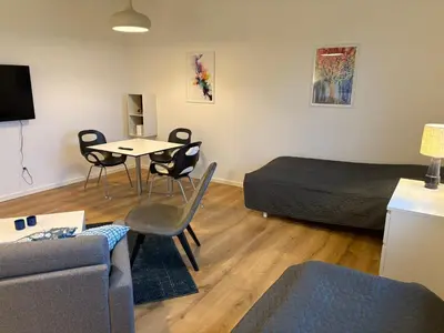 a living room with a bed and a table and chairs at Kildebakkegaard Bed and Breakfast in Nørager