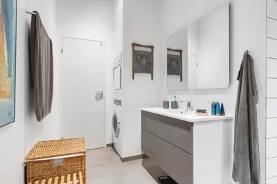 a white bathroom with a sink and a mirror at BL1141-Saltum-Faarup-Klitvej-2-A in Saltum